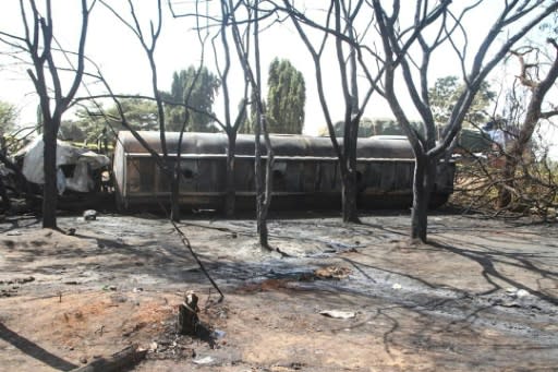 Burnt trees and the carcass of a burnt out fuel tanker is seen along the side of the road following an explosion on August 10, 2019, in Morogoro