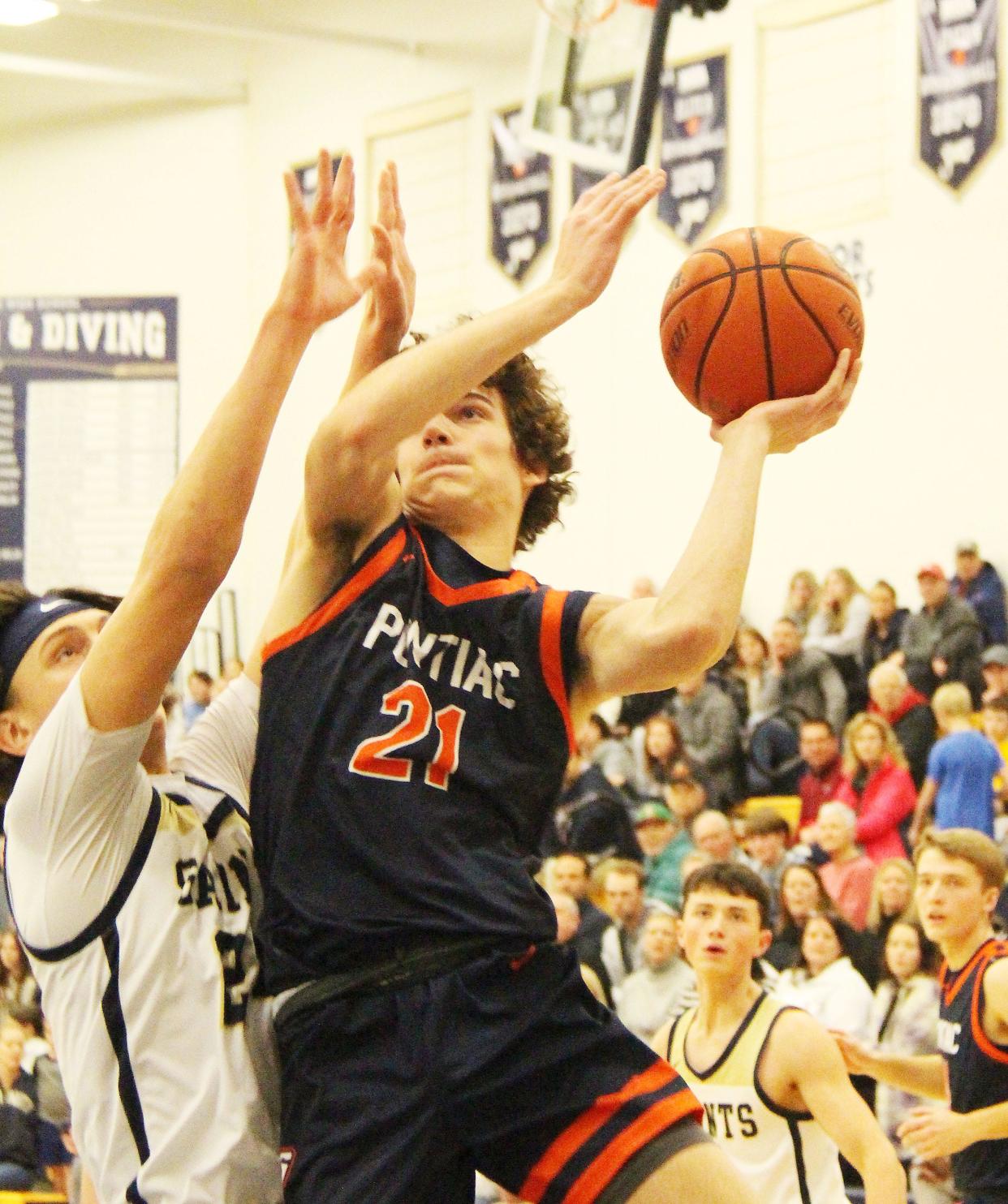 Pontiac's Riley Weber drives in for a basket against Central Catholic Friday. Weber scored 15 points in helping the Indians post a 73-65 victory.