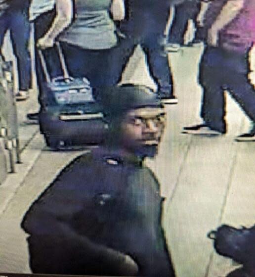 A still from surveillance footage of a man suspected of stabbing and killing a 23-year-old man on the train Friday