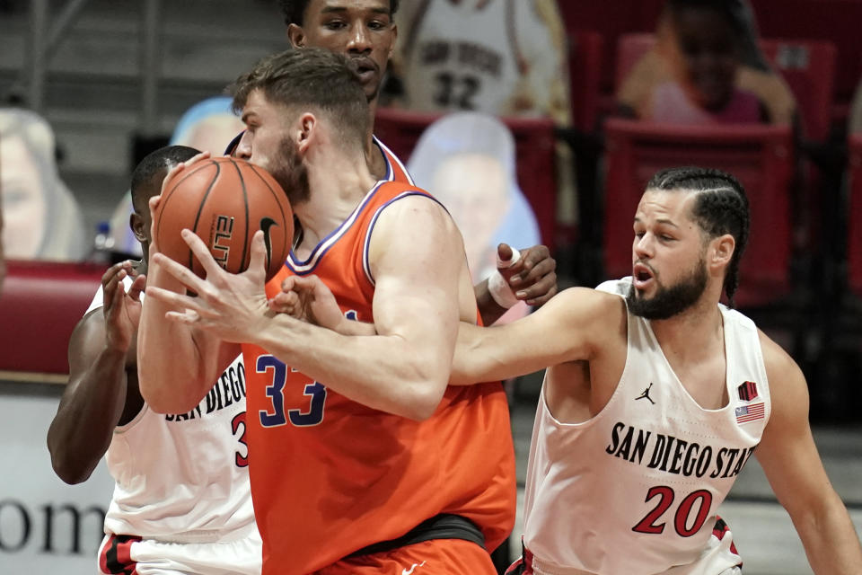 Boise State forward Mladen Armus (33) loses the ball to San Diego State guard Jordan Schakel (20) during the first half of an NCAA college basketball game Saturday, Feb 27, 2021, in San Diego. (AP Photo/Gregory Bull)