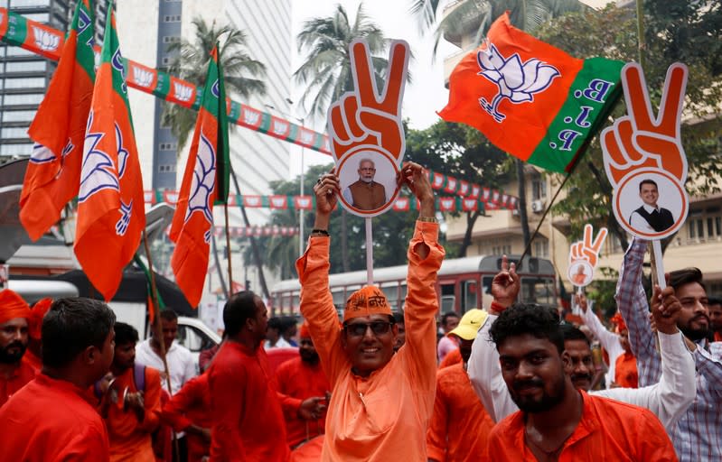 Supporters of BJP (Bharatiya Janata Party) celebrate outside the party office after learning of initial poll results in Mumbai