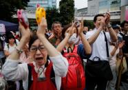 People applaud as they watch an election rally of Reiwa Shinsengumi's candidates for Japan's July 21 upper house election, in Tokyo