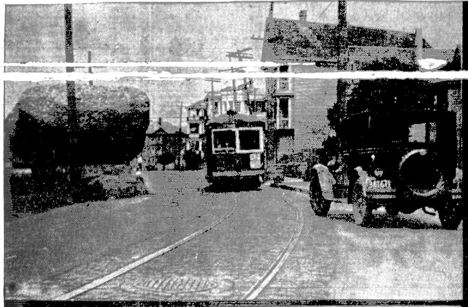 This image published in the Herald News of July 1927 shows how the Rolling Rock stuck out into traffic on County Street before it was preserved, with cars and trolleys rumbling close by.