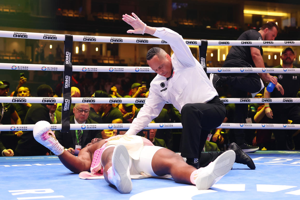 RIYADH, SAUDI ARABIA - MARCH 08: Francis Ngannou is knocked down for the third time as Referee Ricky Gonzalez checks on him during the Heavyweight fight between Anthony Joshua and Francis Ngannou on the Knockout Chaos boxing card at the Kingdom Arena on March 08, 2024 in Riyadh, Saudi Arabia. (Photo by Richard Pelham/Getty Images)