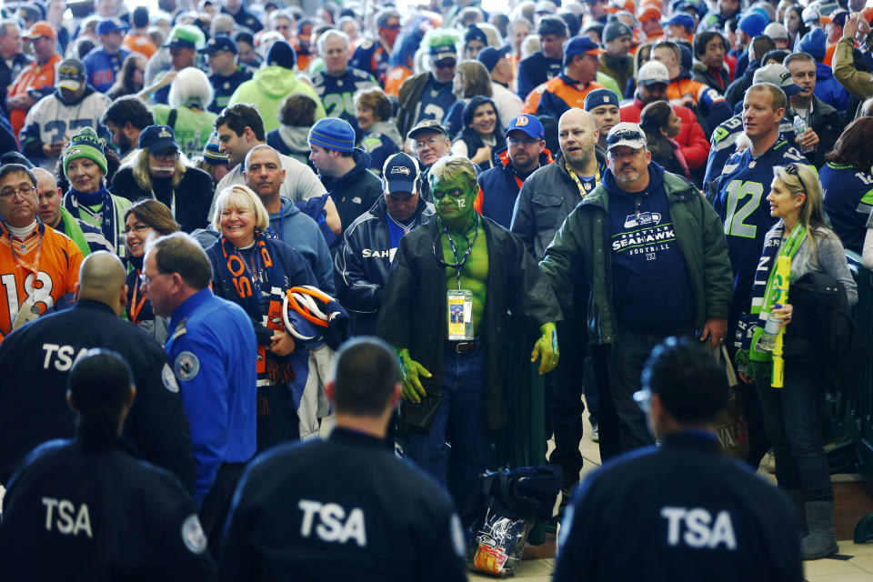 Football fans wait to go through security at the Secaucus Junction, Sunday, Feb. 2, 2014, in Secaucus, N.J. The Seattle Seahawks are scheduled to play the Denver Broncos in the NFL Super Bowl XLVIII football game on Sunday, evening at MetLife Stadium in East Rutherford, N.J. (AP Photo/Matt Rourke)