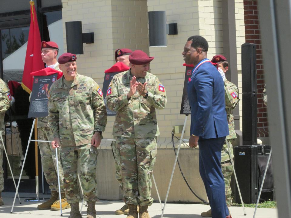 Retired Command Sgt. Maj. Edward Bell far right, is congratulated by  Maj. Gen. Christopher LaNeve, far left and Command Sgt. Maj. Randolph Delapena, second from right, after being inducted into the 82nd Airborne Division Hall of Fame during a ceremony Wednesday, May 24, 2023, at Fort Bragg.