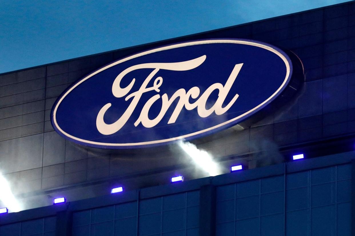 Ford Motor Company' logo is seen on the side of the building at the unveiling of their new electric F-150 Lightning outside of their headquarters in Dearborn, Michigan on May 19, 2021. - One day after winning an enthusiastic endorsement from President Joe Biden, Ford will officially preview the all-electric version of its best-selling F-150 truck on May 19, 2021. The battery-powered Ford F-150 "Lightning" is part of the US auto giant's $22 billion campaign to ramp up its electric vehicle offerings by 2025.