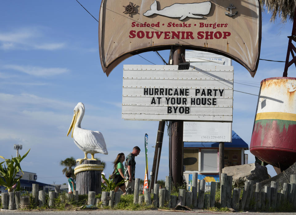 Visitors pass a restaurant closed in advance of Beryl, Saturday, July 6, 2024, in Port Aransas, Texas. (AP Photo/Eric Gay)