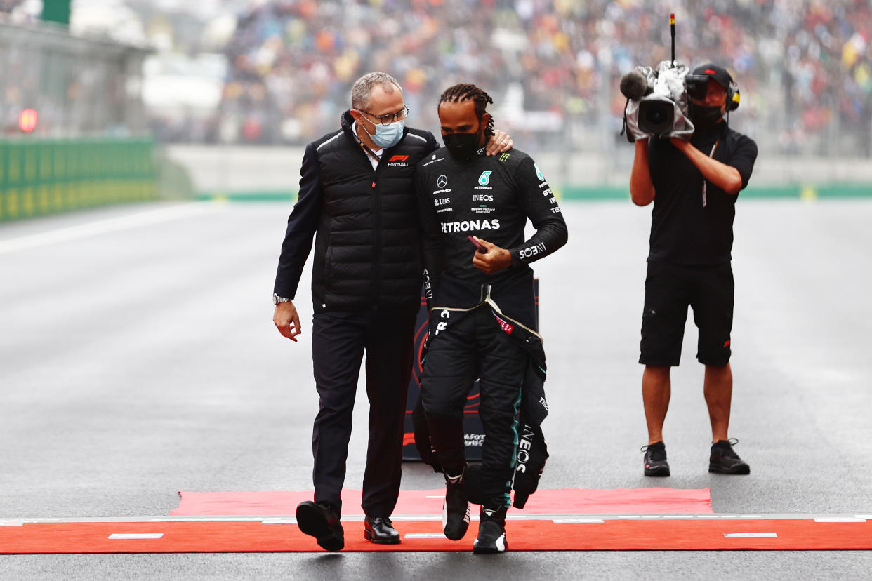 ISTANBUL, TURKEY - OCTOBER 10: Lewis Hamilton of Great Britain and Mercedes GP talks with Stefano Domenicali, CEO of the Formula One Group, on the grid during the F1 Grand Prix of Turkey at Intercity Istanbul Park on October 10, 2021 in Istanbul, Turkey. (Photo by Mark Thompson/Getty Images)