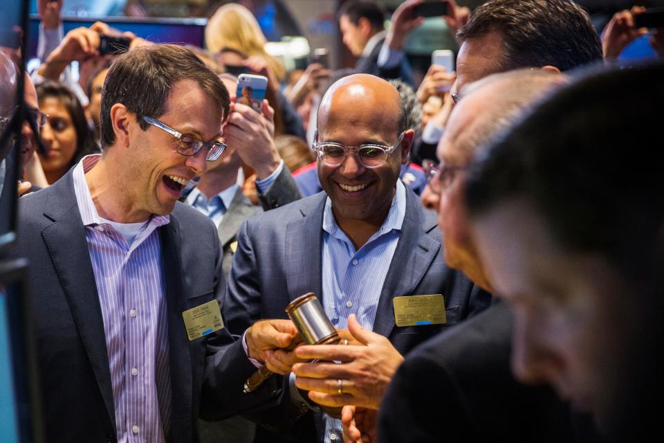 image of Conine and Shah smiling at stock exchange