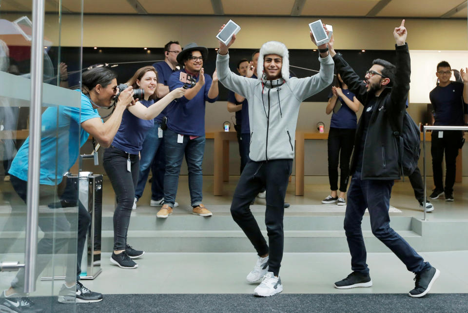 Sydney student Bishoy Bahman (C), 17, reacts as he becomes one of the first customers to walk out of Australia's flagship Apple store with the new iPhone 7 in Sydney, September 16, 2016. REUTERS/Jason Reed TPX IMAGES OF THE DAY