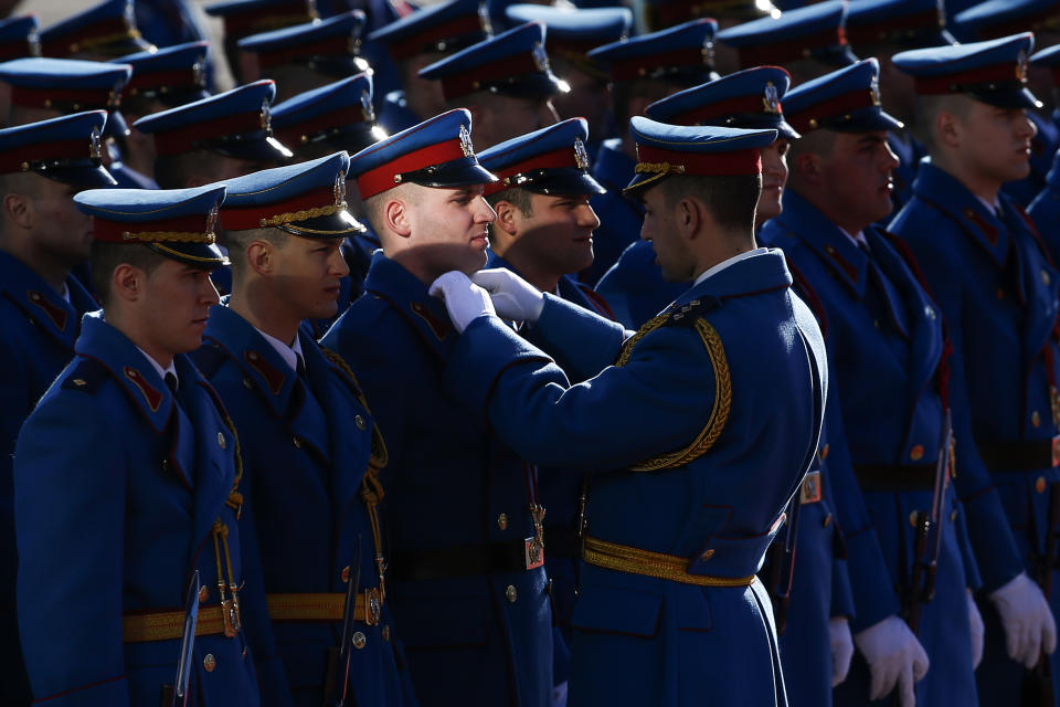 Serbian honor guards prepare themselves for the welcome ceremony for Russian President Vladimir Putin, in Belgrade, Serbia, Thursday, Jan. 17, 2019. Putin arrives in Serbia on Thursday for his fourth visit to the Balkan country since 2001. (AP Photo/Darko Vojinovic)