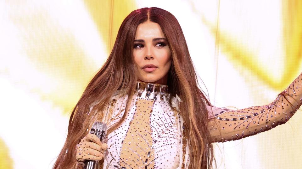 Cheryl on stage with long hair
