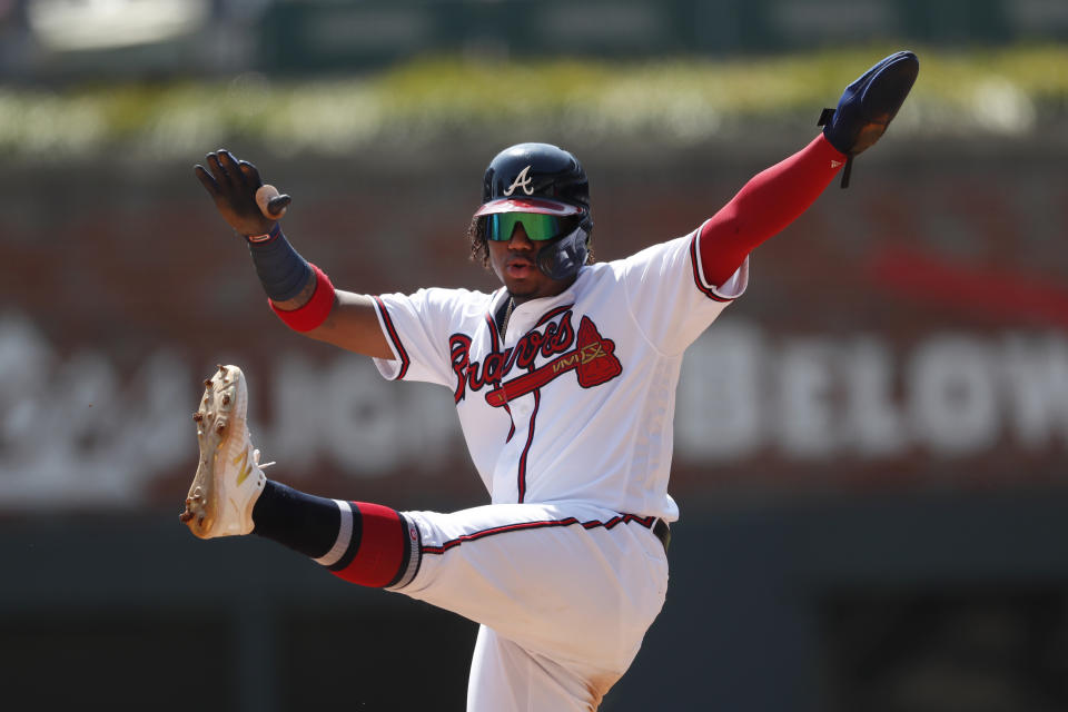 Atlanta Braves center fielder Ronald Acuna Jr. (13) gestures after reaching second base during the fifth inning of a baseball game against the Philadelphia Phillies Thursday, Sept. 19, 2019, in Atlanta. (AP Photo/John Bazemore)