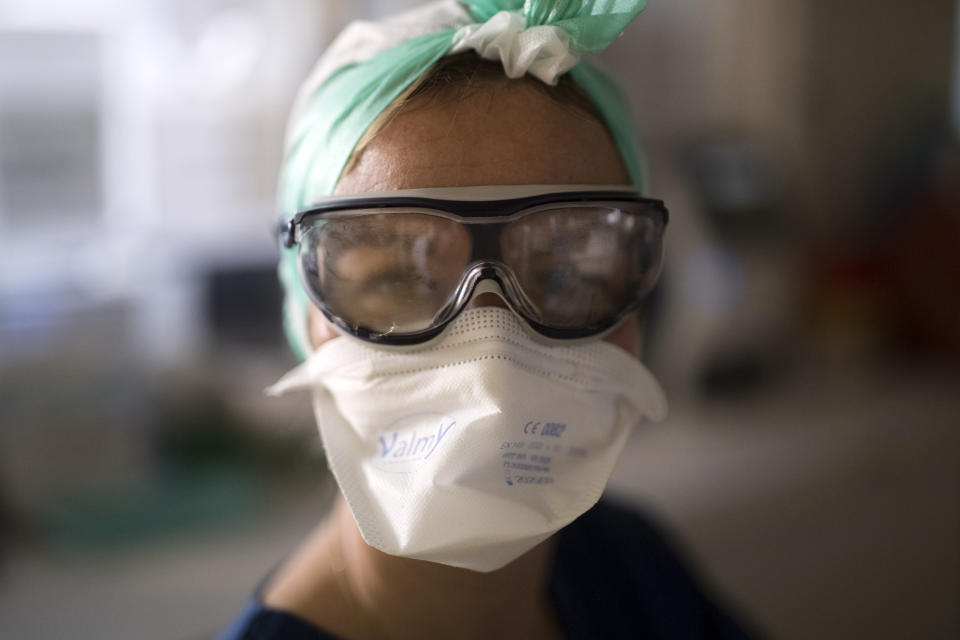 A healthcare worker with fogged protective eyewear poses for a portrait in the intensive care unit at the Joseph Imbert Hospital Center in Arles, southern France, Wednesday, Oct. 28, 2020. Many French doctors are urging a new nationwide lockdown, noting that 58% of the country's intensive care units are now occupied by COVID patients and medical staff are under increasing strain. (AP Photo/Daniel Cole)