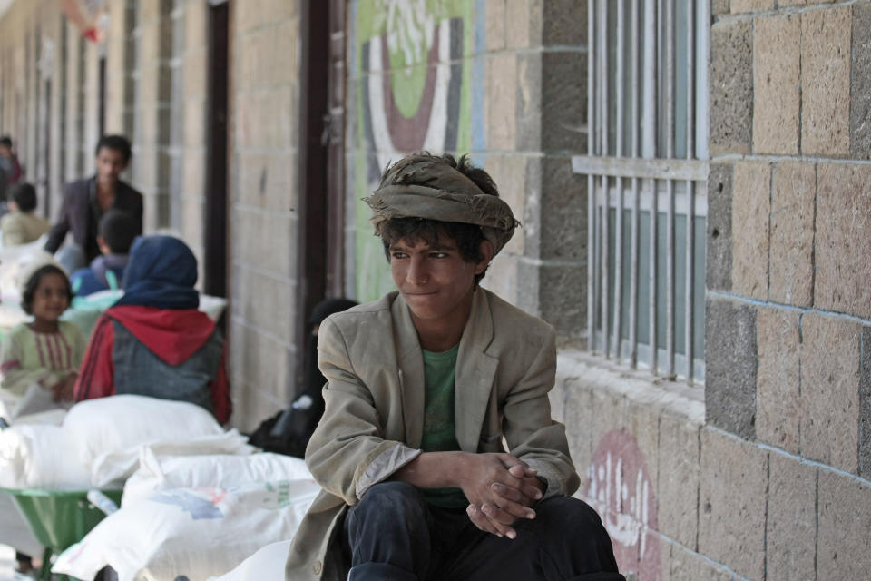 A boy waits for food supplies provided by the World Food Programme at a school in Sanaa, Yemen, Sunday, Aug. 25, 2019. The U.N. humanitarian chief in Yemen warned last Wednesday that unless significant new funding is received in the coming weeks, food rations for 12 million people in the war-torn country will be reduced and at least 2.5 million malnourished children will be cut off from life-saving services. (AP Photo/Hani Mohammed)