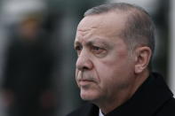 Turkey's President Recep Tayyip Erdogan, stands during the welcome ceremony of Malta's President Marie-Louise Coleiro Preca prior to their meeting at the Presidential Palace in Ankara, Turkey, Thursday Jan. 24, 2019. Erdogan said Turkey opposes coup attempts wherever they may occur.Erdogan, who did not directly reference Venezuela, made the comments at a military academy Thursday hours after he spoke with Venezuela's President Nicolas Maduro.(AP Photo/Burhan Ozbilici)