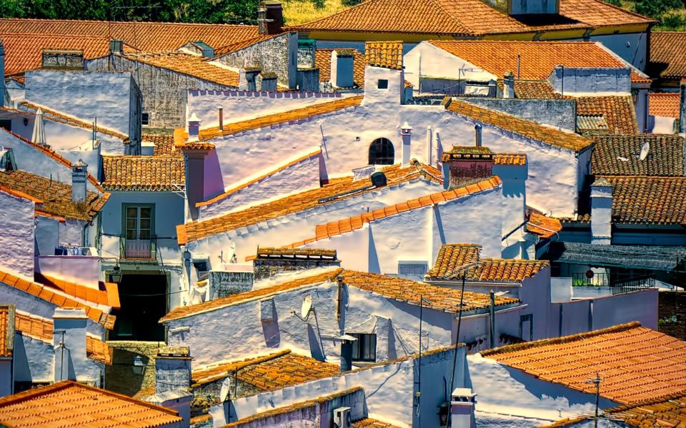 The terracotta rooftops and whitewashed walls of Evora - Claude Le Tien/Getty