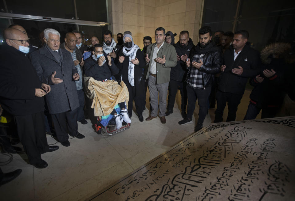 Former Palestinian prisoner Khaled Fasfous sits as he prays at the tomb of Palestinian leader Yasser Arafat after being released, in the West Bank city of Ramallah, Sunday, Dec. 5, 2021. Israel released Fasfous, two weeks after striking a deal that ended his marathon 131-day hunger strike. Fasfous was the symbolic figurehead of six hunger strikers protesting Israel’s controversial policy of “administrative detention” that allows suspects to be held indefinitely without charge for months and even years (AP Photo/Majdi Mohammed)