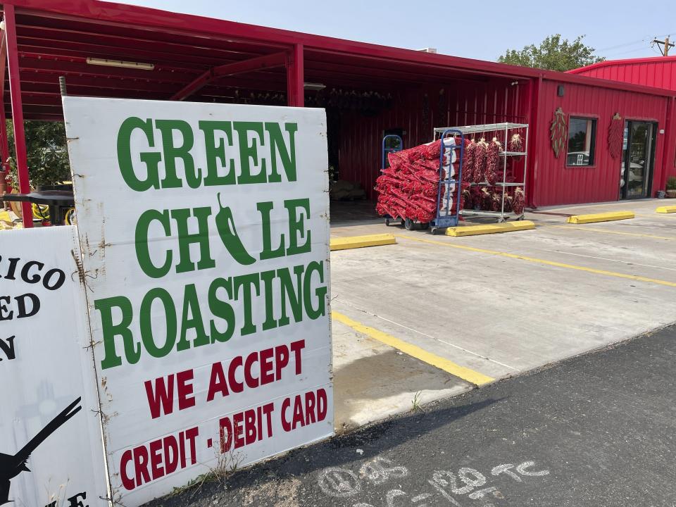 FILE - This July 12, 2021 image shows the front of Grajeda Hatch Chile Market in Hatch, New Mexico, where the roasting season is under way. Farmers say the season is shaping up to be a good one. There's nothing like the sweet smell of green chile roasting on an open flame. It permeates New Mexico every fall, wafting from roadside stands and grocery store parking lots, inducing immediate salivation and visions of mouth-watering culinary wonders laden with hot peppers. Democratic Sen. Bill Soules is proposing that roasted green chile become the official state aroma. (AP Photo/Susan Montoya Bryan, File)