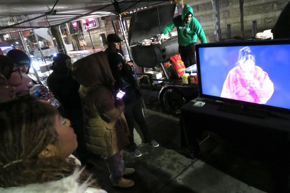 Fans watch the halftime show at the BBQ clubhouse on 12th and Filbert in Philadelphia on Sunday February 12, 2023