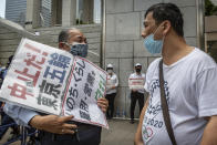 <p>An anti-Olympics protester and a pro-Olympics man argue during a protest against Tokyo 2020 Olympics on July 23, 2021 in Tokyo, Japan. Protesters gathered to demonstrate against the Olympic Games amid concern over the safety of holding the event during the global coronavirus pandemic as well as the cost incurred. (Photo by Yuichi Yamazaki/Getty Images)</p> 