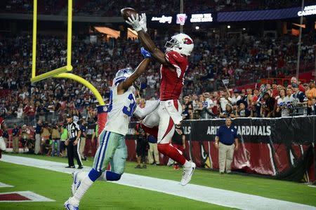 Sep 25, 2017; Glendale, AZ, USA; Arizona Cardinals wide receiver Jaron Brown (13) goes up for the ball over Dallas Cowboys cornerback Anthony Brown (30) but is unable to make a catch during the second half at University of Phoenix Stadium. Mandatory Credit: Joe Camporeale-USA TODAY Sports