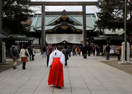 A Shinto priestess bows at the Yasukuni Shrine in Tokyo, Japan, December 29, 2016. REUTERS/Toru Hanai