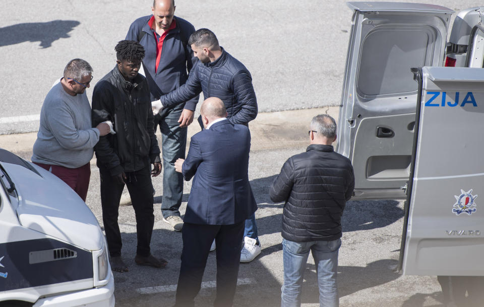 A migrant, suspected to be involved in the hijack of the Turkish oil tanker El Hiblu 1, is taken into custody in Valletta, Malta, Thursday March 28, 2019. A Maltese special operations team on Thursday boarded a tanker that had been hijacked by migrants rescued at sea, and returned control to the captain, before escorting it to a Maltese port. (AP Photo/Rene' Rossignaud)