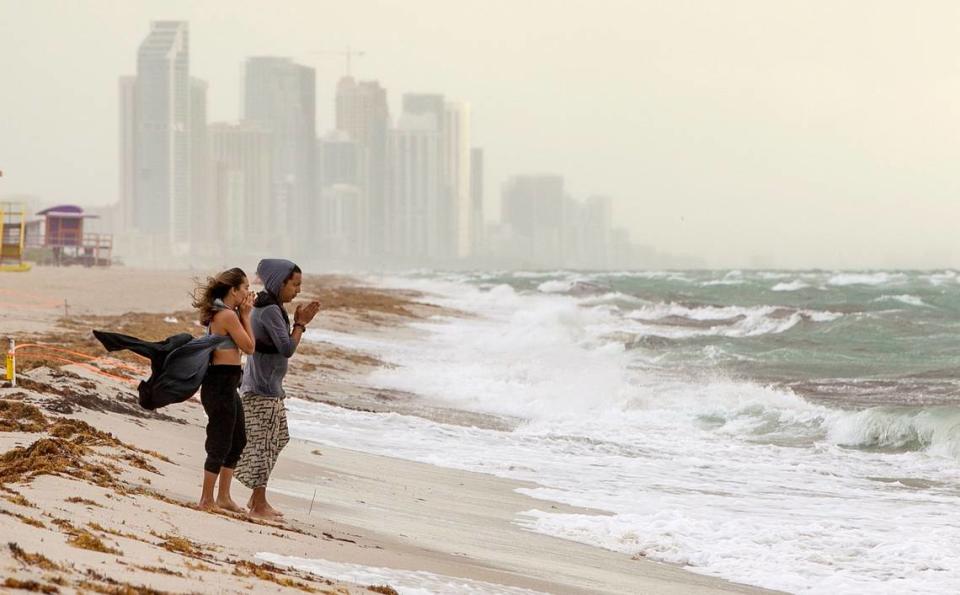 A couple walked on the beach by the 71st Street area in Miami Beach on Saturday, Aug. 1, 2020. Hurricane Isaias was forecast to brush Florida’s Atlantic coast that night.