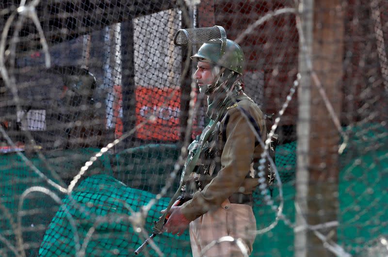 FILE PHOTO: An Indian policeman stands guard outside a bunker alongside a road in Srinagar