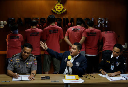 National Police Cyber Crime Director Brig. Gen. Fadil Imran (C), gestures in front of suspects arrested for cyber-crime related hoaxes on social media during a press conference in Jakarta, Indonesia February 28, 2018. REUTERS/Darren Whiteside