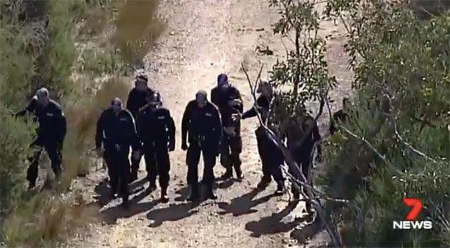 Police search through bushland near Waterfall Train Station. Source: 7News