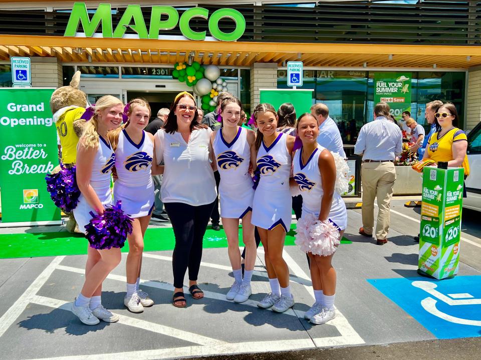 MAPCO Media and Community Relations Coordinator Bobbe Morhiser stands with Columbia Central High School cheerleaders at the new MAPCO on 2301 Carmack Blvd.