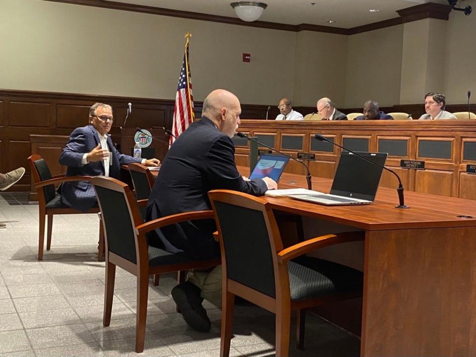 Concerned resident Steve Neil, of Rockfoot Drive (far left),  describes his worries for the traffic in the neighborhood as the Jackson City Planning Director, Steve Pilant (middle) looks on.