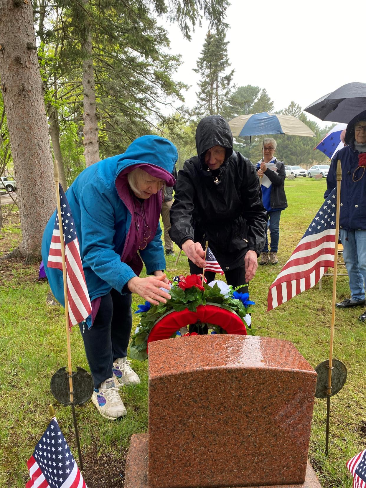 Daughters of the American Revolution members Carol Berens and Jane Johnson set up a wreath on May 25 at the grave of the unknown soldier in Pine Grove Cemetery in Wausau.