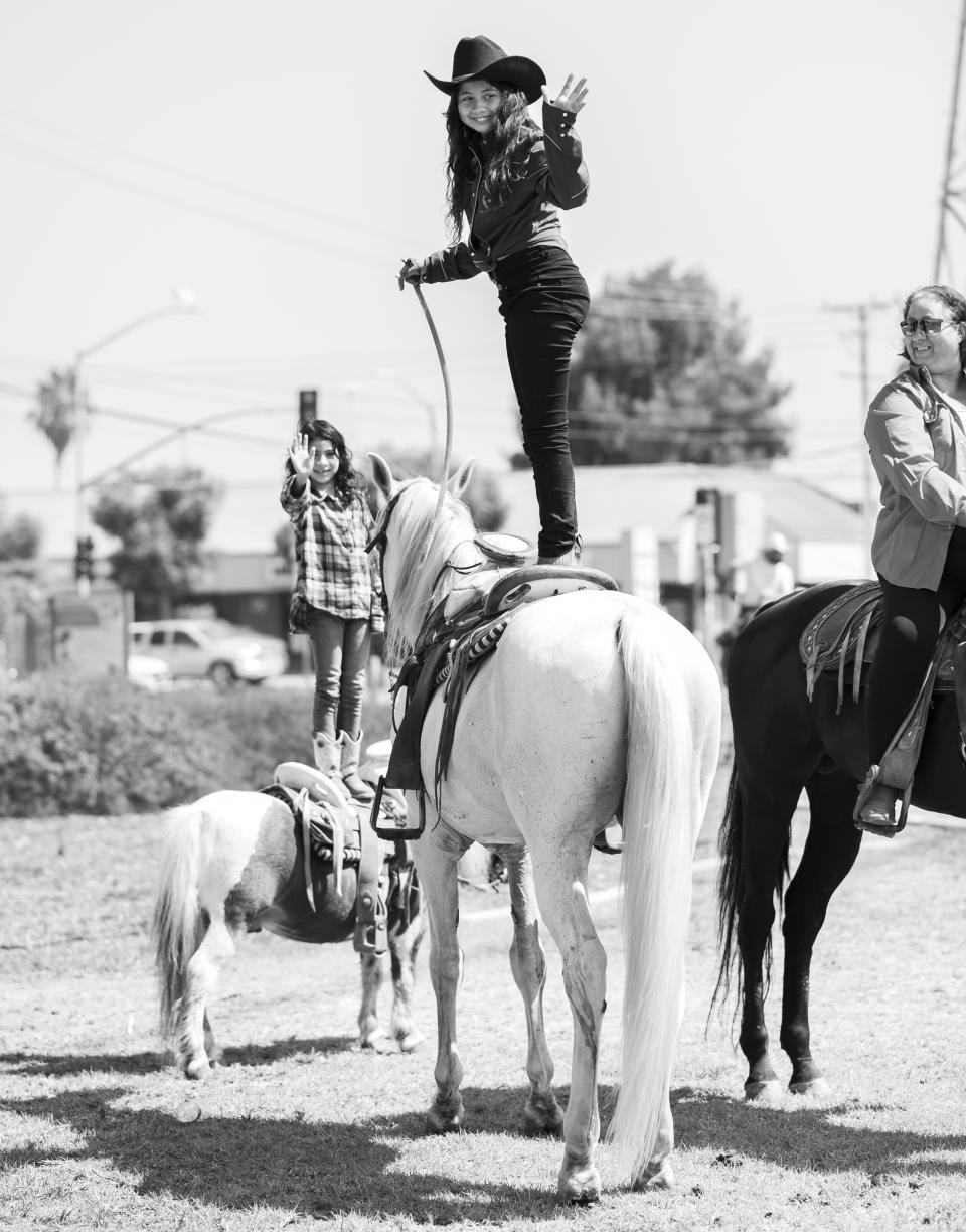 Two courageous sisters, Mia, 12, and Andrea, 7, demonstrate the trust and connection they have with their horses. (Connecting Compton)