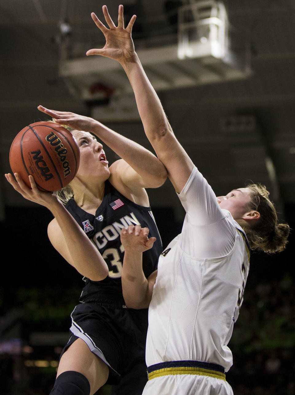 Connecticut's Katie Lou Samuelson, left, goes up for a shot with pressure from Notre Dame's Jessica Shepard during the first half of an NCAA college basketball game Sunday, Dec. 2, 2018, in South Bend, Ind. (AP Photo/Robert Franklin)