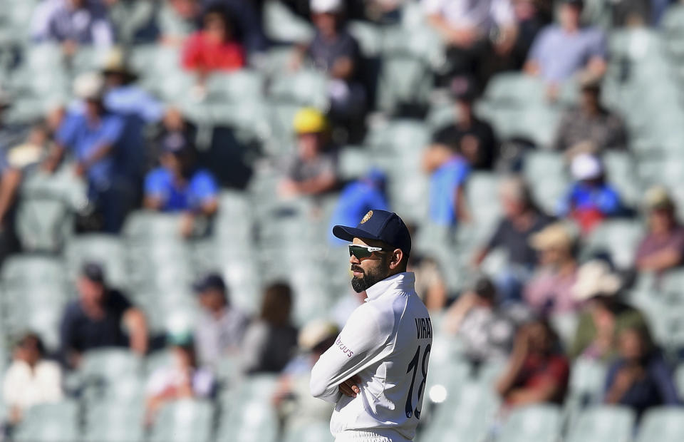 India's Virat Kohli stands with crossed arms near the end of their match against Australia on the third day of their cricket test match at the Adelaide Oval in Adelaide, Australia, Saturday, Dec. 19, 2020. Australia won the match. (AP Photo/David Mariuz)