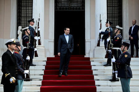 FILE PHOTO: Greek Prime Minister Alexis Tsipras waits to welcome Irish President Michael Higgins (not pictured) at the Maximos Mansion in Athens, Greece, February 22, 2018. REUTERS/Alkis Konstantinidis/File Photo