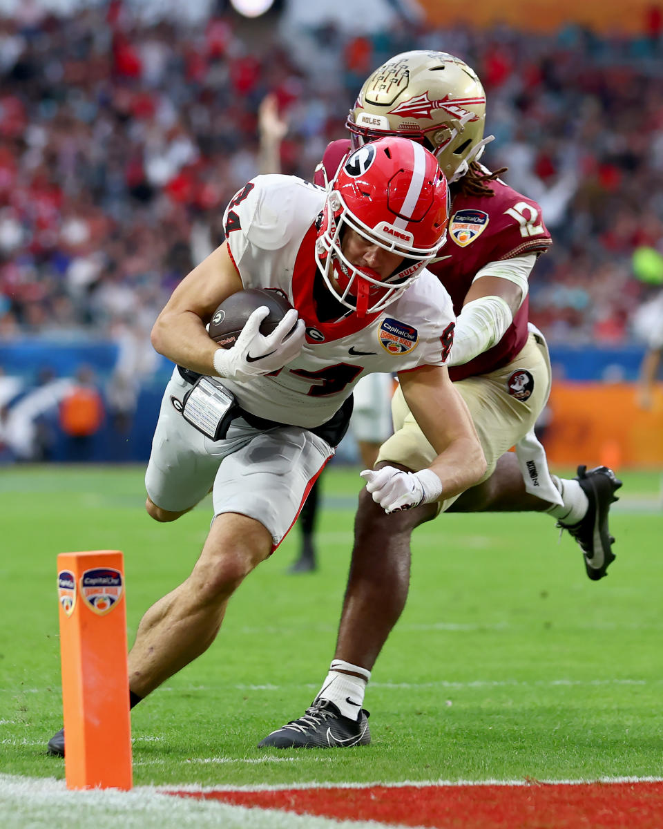 MIAMI GARDENS, FLORIDA – DECEMBER 30: Ladd McConkey #84 of the Georgia Bulldogs scores a touchdown past Conrad Hussey #12 of the Florida State Seminoles in the second quarter during the Capital One Orange Bowl at Hard Rock Stadium on December 30, 2023 in Miami Gardens, Florida. (Photo by Megan Briggs/Getty Images)