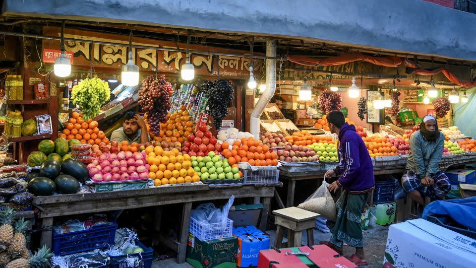 Fruit sellers at a wholesale market in Dhaka on January 21, 2024 - Munir Uz Zaman/AFP/Getty Images