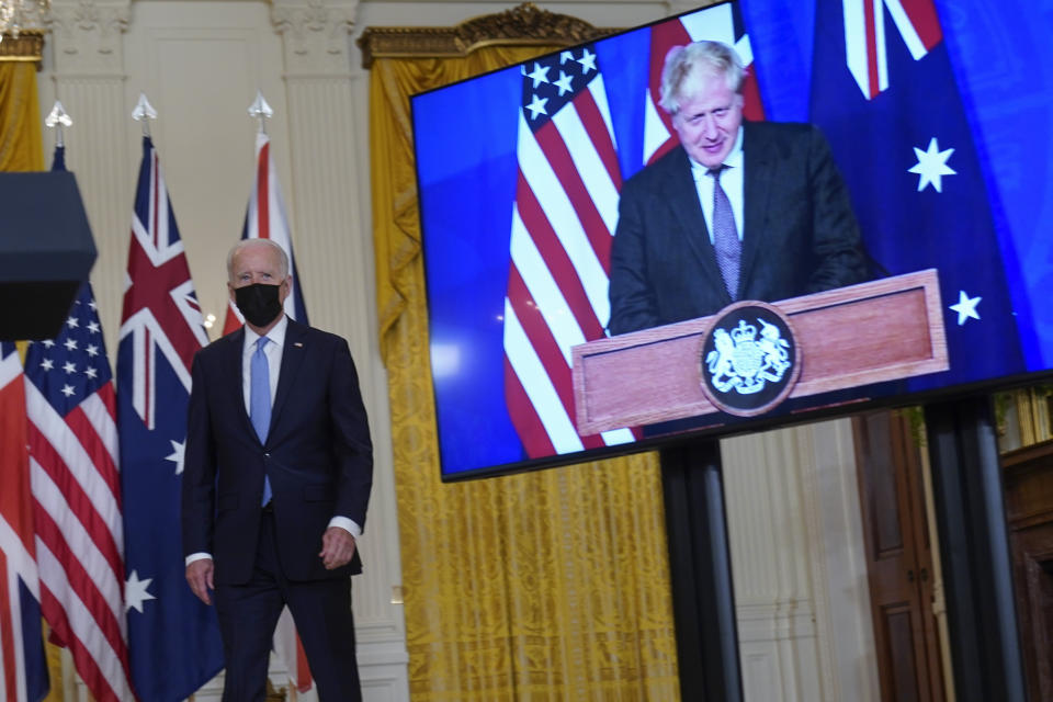 President Joe Biden, arrives and is joined virtually by Australian Prime Minister Scott Morrison and British Prime Minister Boris Johnson, right, to speak about a national security initiative from the East Room of the White House in Washington, Wednesday, Sept. 15, 2021. (AP Photo/Andrew Harnik)