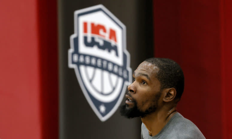 Kevin Durant sitting in front of a Team USA basketball logo.