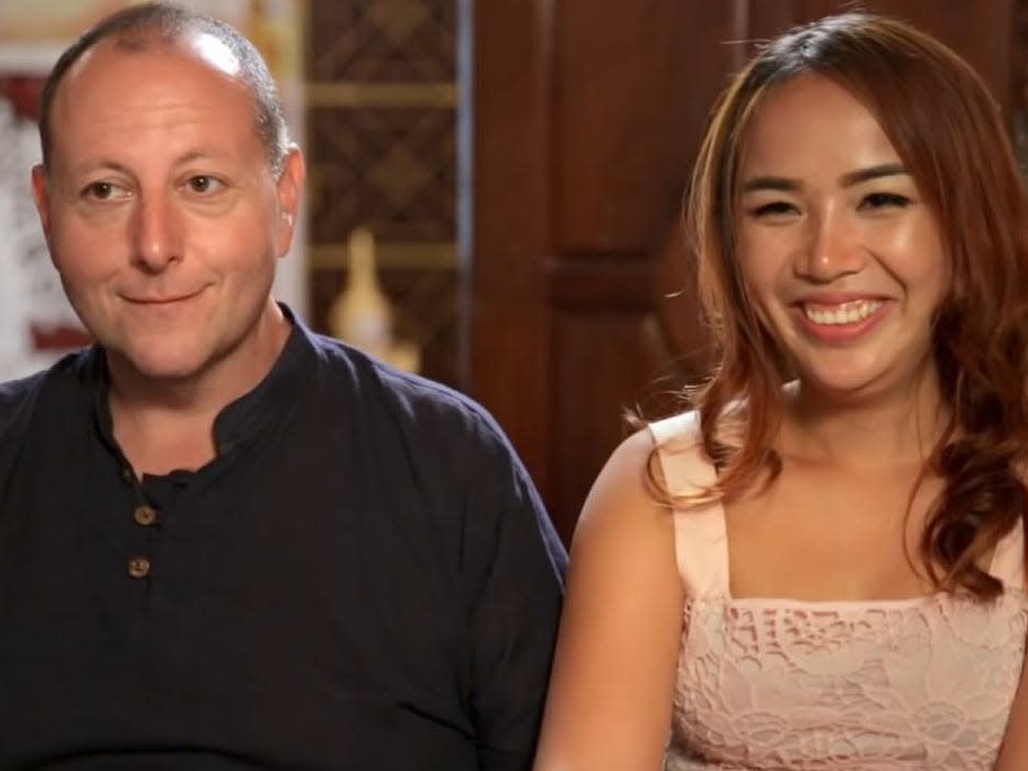 David Toborowsky and Annie Suwan facing camera on set of "90 day fiance"