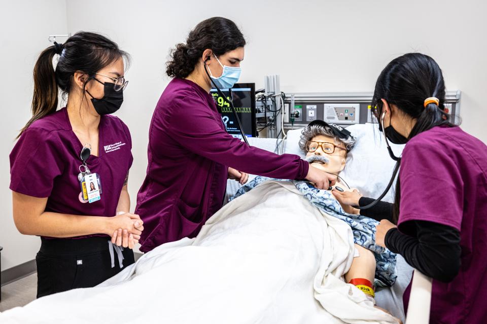 Elliana Tenenbaum works with her classmates at Arizona State University's Edson College of Nursing and Health Innovation during a clinical simulation.