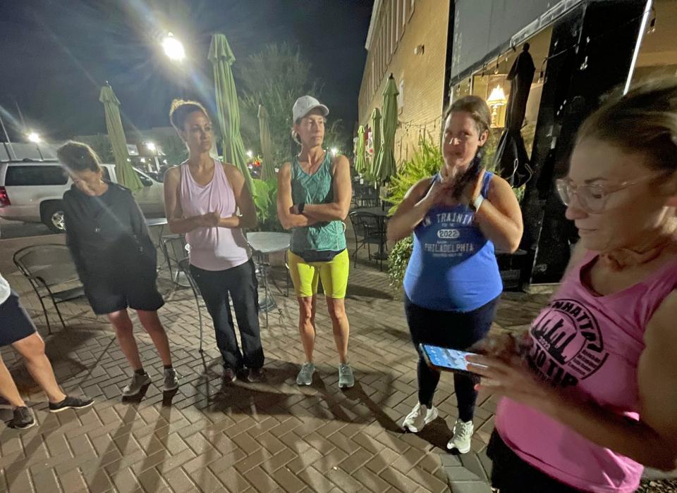 Local runners listen as Kellie Vanhoy gives a short speech early Friday morning before they head off for a five mile run. The run was organized as a way to bring attention to safety for women and pay tribute to Eliza Fletcher, a Tennessee woman who was abducted and killed last week.