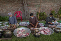 Kashmiri Wazas, or chefs, chop mutton before cooking for a wedding feast Wazwan on outskirts of Srinagar, Indian controlled Kashmir, Tuesday, Sept. 16, 2020. The coronavirus pandemic has changed the way people celebrate weddings in Kashmir. The traditional week-long feasting , elaborate rituals and huge gatherings have given way to muted ceremonies with a limited number of close relatives attending. With restrictions in place and many weddings cancelled, the traditional wedding chefs have little or no work. The virus has drastically impacted the life and businesses in the region. (AP Photo/ Dar Yasin)