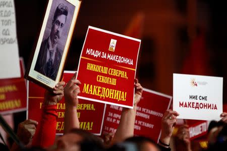 Protestors hold banners during a protest against the change of the country's constitutional name in front of the Parliament building in Skopje, Macedonia June 23, 2018. REUTERS/Ognen Teofilovski