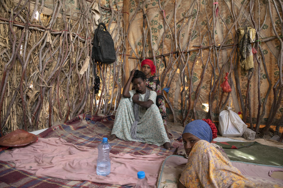 In this July 25, 2019 photo, Ethiopian migrant girls sit inside in a compound known in Arabic as a "hosh," in Ras al-Ara, Lahj, Yemen. Meanwhile, more than 150,000 migrants landed in Yemen in 2018, a 50% increase from the year before, according to the International Organization for Migration. (AP Photo/Nariman El-Mofty)